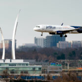 A JetBlue plane lands at Reagan Washington National Airport in Arlington, Va.