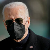 Joe Biden wears a mask and walks on the South Lawn of the White House.