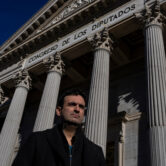 A clergy abuse victim in front of a Spanish parliament.