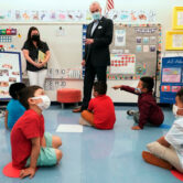 Phil Murphy talks to students in a pre-K class while all wear masks.