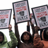 Demonstrators hold signs in support of Trayvon Martin in New York.