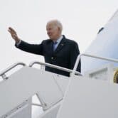President Biden waves as he boards Air Force One