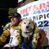 Winner of Iditarod race and one of his dogs.
