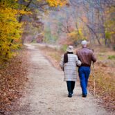 Elderly couple walking on a dirt path