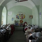 Afghan girls participate in a lesson inside a classroom at Tajrobawai Girls High School.