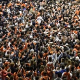 Illinois fans storm the court after a NCAA college basketball game against Iowa.