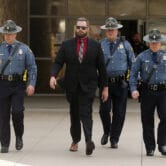 Arkansas State Troopers escort Michael Davis after his conviction.