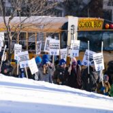 Striking Minneapolis teachers picket outside a middle school