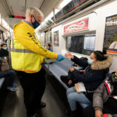 Patrick Foye hands out face masks on a New York City subway.