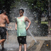 People gathered at Salmon Street Springs water fountain in Portland to cool off.