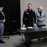 Alexei Navalny stands next to his lawyers during a court hearing in Russia.