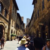People on a street in a Tuscan village.