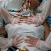 Nurses perform timed breathing exercises on a Covid-19 patient on a ventilator.