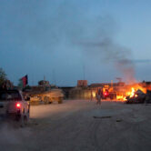 A vehicle approaches a toxic burn pit at a NATO installation in Afghanistan.