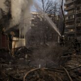 Firefighters work to put out a blaze after a bombing in Kyiv, Ukraine