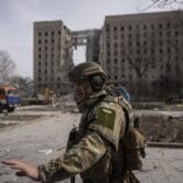 A Ukrainian soldier secures the area of a Russian attack