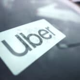 An Uber sign is displayed inside a car in Palatine, Ill.