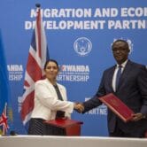 Britain’s home secretary shakes hands with Rwanda’s minister of foreign affairs