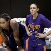 Phoenix Mercury basketball player Brittney Griner watches practice with teammate Diana Taurasi.