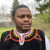 Cameroonian refugee Wilfred Tebah poses for a photo in his backyard in Ohio.