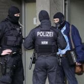 Police investigate in Düsseldorf, Germany, as part of raids in several German cities.