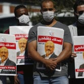 People hold posters of Jamal Khashoggi near the Saudi Arabian consulate in Istanbul.