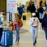 Travelers wear face masks to protect against Covid-19 at the Philadelphia International Airport.