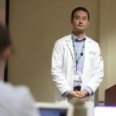An associate director of an OB-GYN residency program leads a lecture.