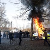 Protesters set fire to a police bus in a park in Sweden.