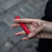 A woman holds a Puff Bar flavored disposable vape device in New York.
