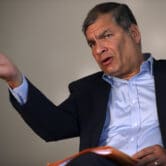 Rafael Correa gestures during an interview in Brussels.