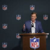Roger Goodell answers questions from reporters at a press conference.