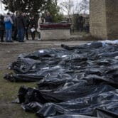 This image shows body bags in a cemetery in Bucha, Ukraine