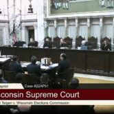 Justices and lawyers in the Wisconsin Supreme Court hearing room ahead of arguments in a lawsuit over election drop boxes.
