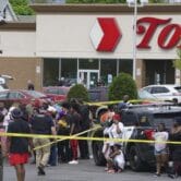 People gather outside a supermarket where several people were killed in a shooting in Buffalo, N.Y.