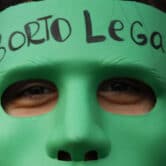 An abortion-rights activist wears a mask that reads "Legal Abortion" in Spanish in Argentina.