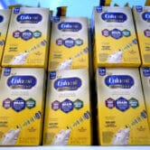 Infant formula is stacked on a table during a baby formula drive to help with a U.S. shortage.