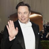 Elon Musk waves at the Met Gala in New York.