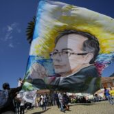 A supporter holds a flag with the image of Gustavo Petro in Colombia.