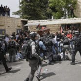 Israeli police confront mourners as they carry the coffin of Shireen Abu Akleh during her funeral.