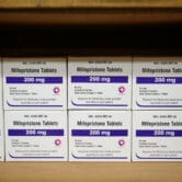 Boxes containing an abortion pill line a shelf in a women's center in Alabama.