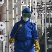 A North Korean worker disinfects a factory floor amid a Covid-19 outbreak.