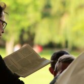A pastor reads from a book