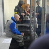 Vadim Shishimarin is seen behind glass during a court hearing in Kyiv, Ukraine.