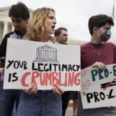 Demonstrators protest outside of the U.S. Supreme Court in Washington.
