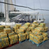 Bales of cocaine and a seized yacht are displayed in Portugal.