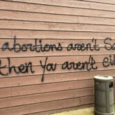 Threatening graffiti is seen on the exterior of Wisconsin Family Action offices.