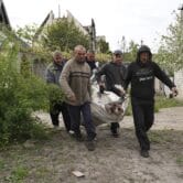 Civilian bodies are carried in Stepaky, Ukraine