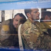 Ukrainian servicemen sit in a bus after they were evacuated from a Mariupol steel plant.