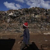 A waste picker rummages through garbage at a dumping site in Johannesburg, South Africa.